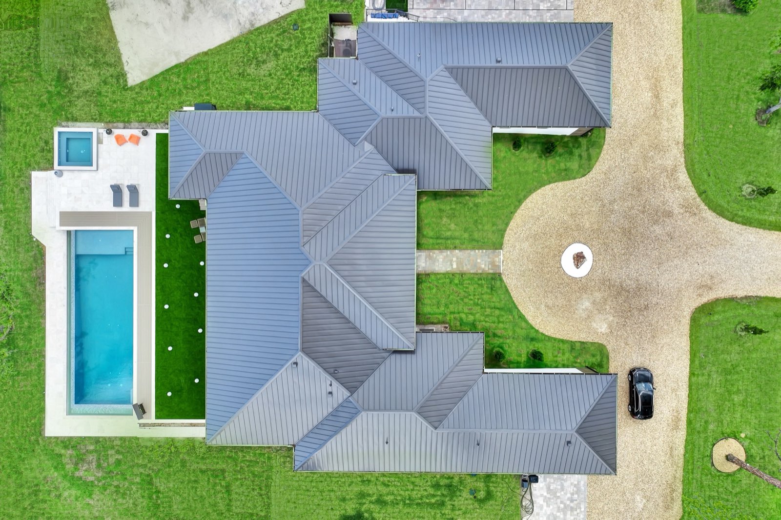 Top-down aerial of a standing seam metal residential roof